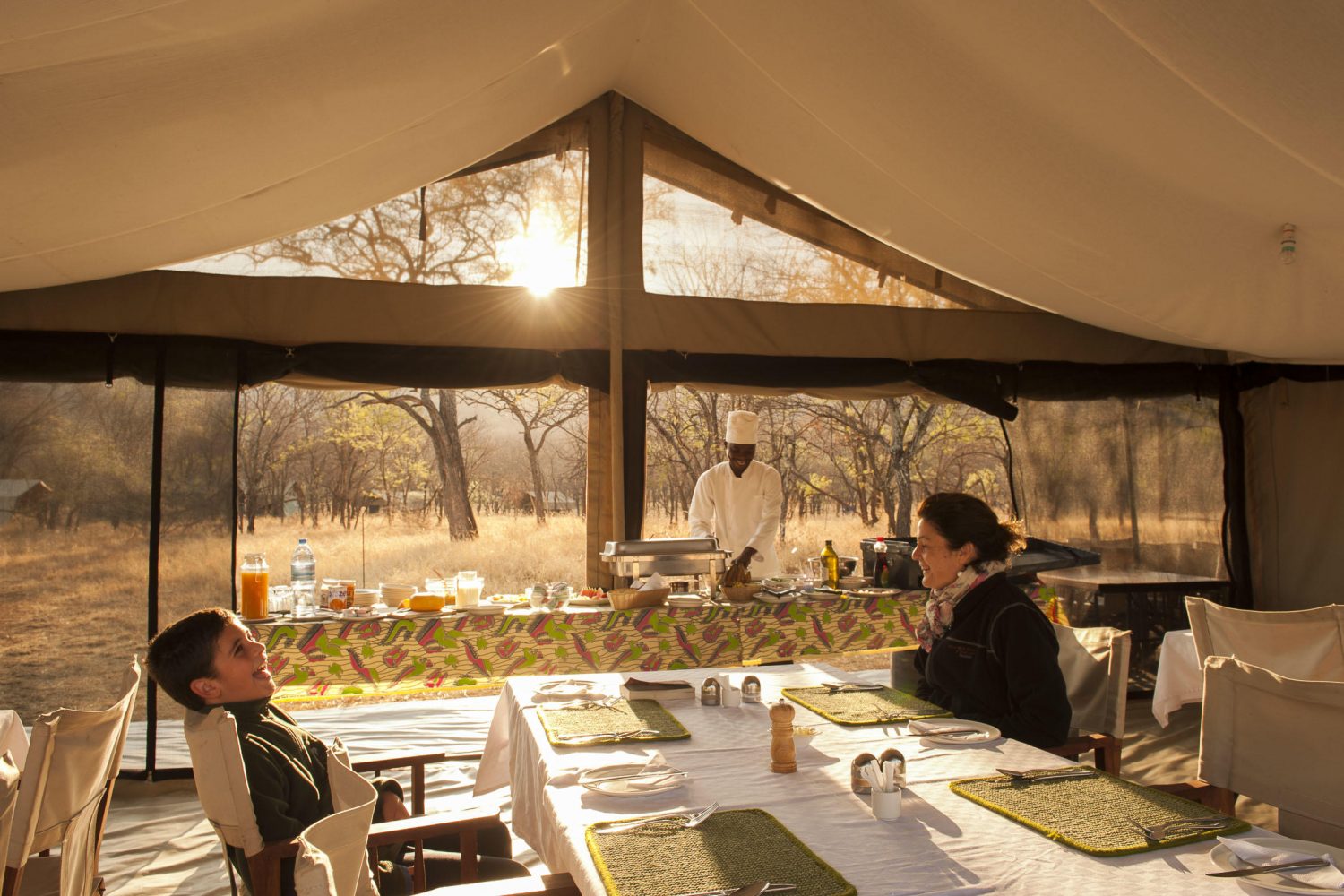 Chef preparing a hearty breakfast at Kati Kati Tented Camp in Tanzania’s Serengeti National Park before a Big Five safari.