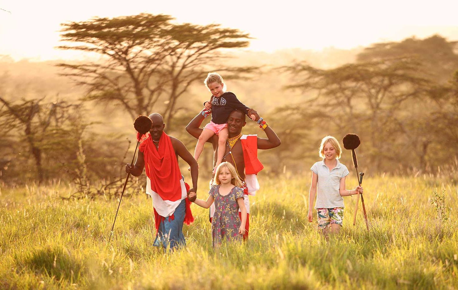 Young children learning about animal tracks with a safari guide